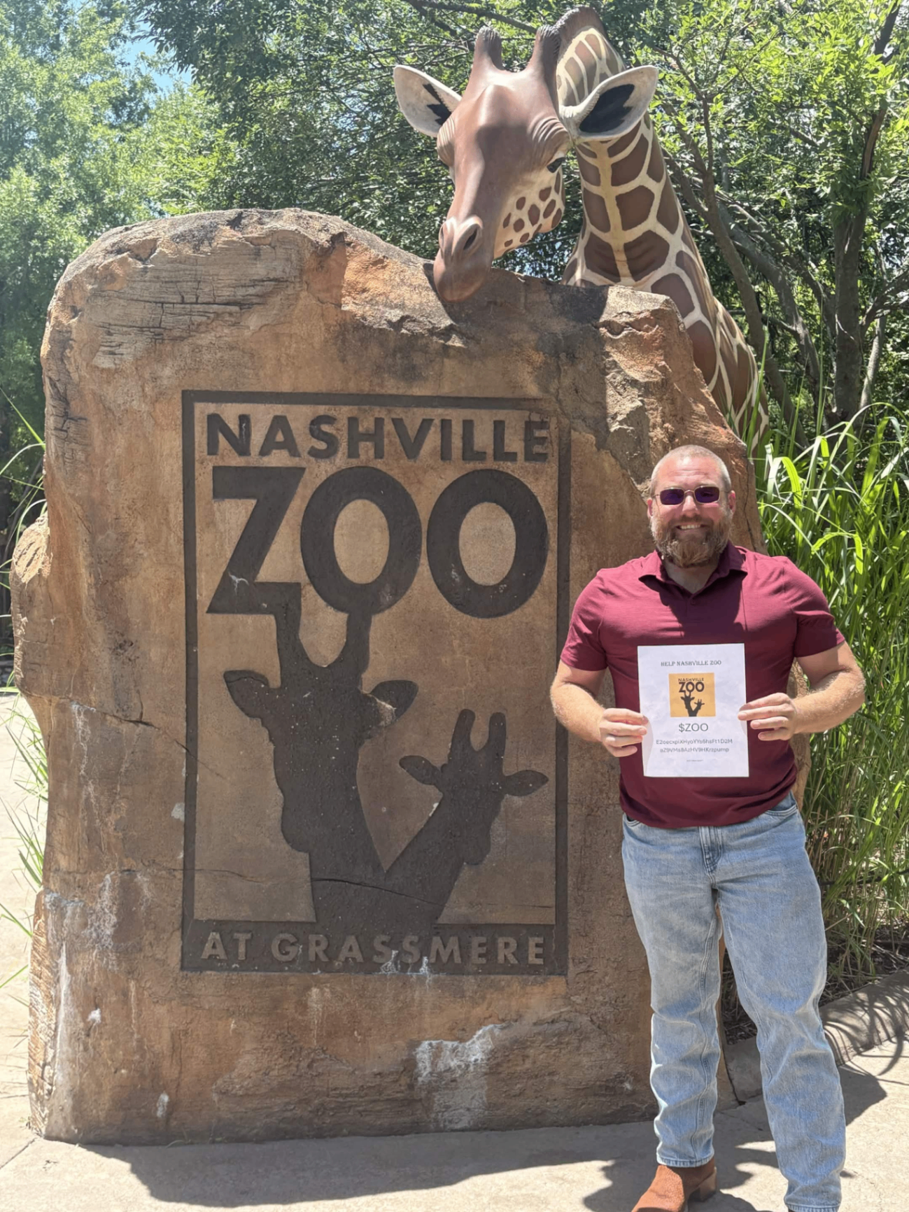 Supporter at Nashville Zoo entrance holding a $ZOO flyer